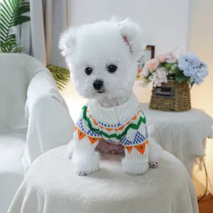 Close-up of ivory pet knit sweater featuring colorful geometric jacquard patterns