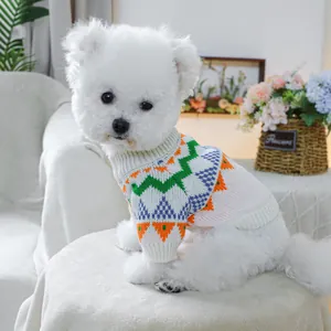 Close-up of a cozy pet knit sweater with colorful geometric patterns on a white dog