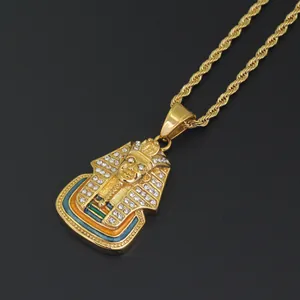 Close-up of golden Egyptian Pharaoh pendant with rhinestones and rope chain detail