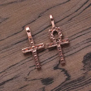 Macro detail of rose gold Ankh and classic cross pendants with micro-pave cubic zirconia