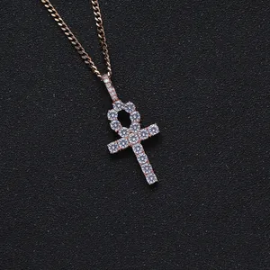 Macro shot of rose gold Ankh cross pendant with pavé set cubic zirconia on black background