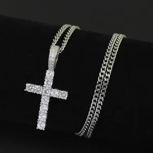 Macro view of iced out Ankh cross pendant with micro-pave zircons on curb link chain