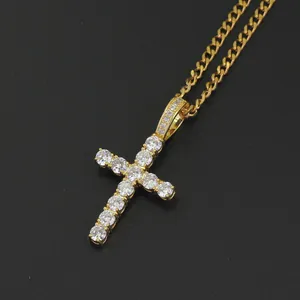 Macro detail of gold Ankh cross pendant with micro-paved zircons on a cuban chain