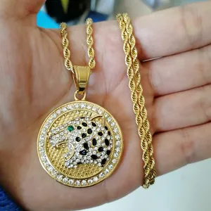 Close-up of leopard head pendant with green eyes and crystal inlay on gold rope chain