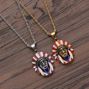 Detail of silver and gold Indian chief pendants with red, white and blue enamel accents