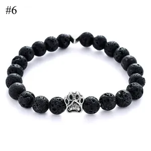Detail of 8mm black lava stone beads with a vintage silver pet paw charm on an elastic bracelet