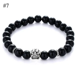 Detail of 8mm black beads bracelet with silver paw charm and metallic spacers