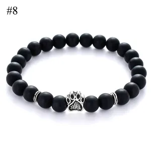 Detail of 8mm matte black beads bracelet with silver animal paw charm and textured spacers