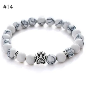Detailed close-up of 8mm white turquoise beads bracelet with a silver paw charm
