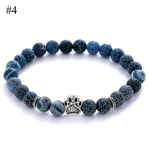 8mm dark blue cracked stone bead bracelet with silver animal paw charm on white background