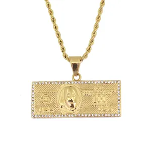 Macro shot of gold-plated dollar bill pendant with crystal borders and rope chain