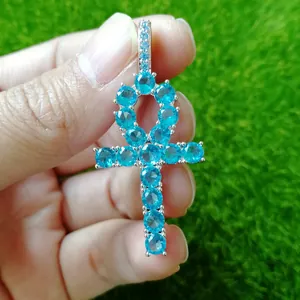 Close-up of hip hop Ankh cross pendant in silver with vibrant blue zircon stones