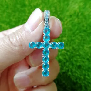 Detailed close-up of a silver Ankh cross pendant with vibrant blue zirconia stones