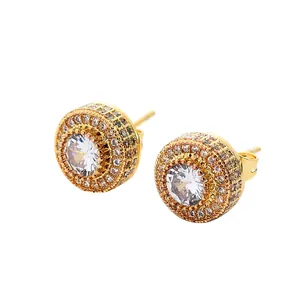 Detail view of gold stud earrings with large round zircon and double halo setting