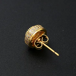 Macro view of gold plated micro-pave zircon stud earrings with butterfly back fasteners