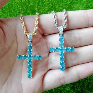 Detailed shot of iced out blue zircon Ankh cross pendants in gold and silver rope chains