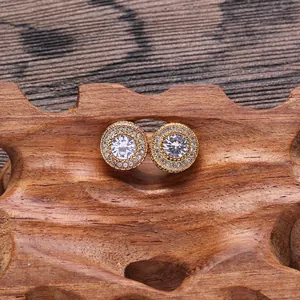Macro shot of gold-plated round stud earrings with shimmering cubic zirconia stones