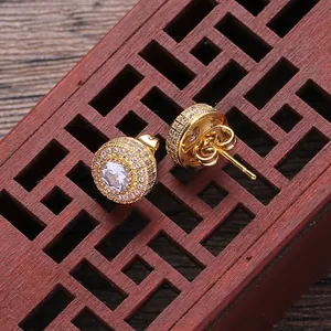 Close-up of gold round halo stud earrings with brilliant zircon and butterfly backs