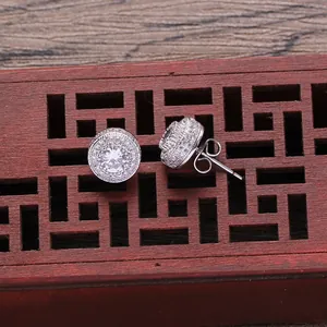 Macro shot of silver hip hop stud earrings with shimmering round cubic zirconia cluster