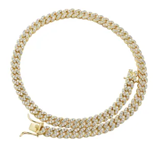 Close-up of gold Cuban link chain with detailed safety clasp and cubic zirconia settings