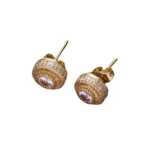 Gold-plated hip hop earrings featuring large round cubic zirconia center and halo stones