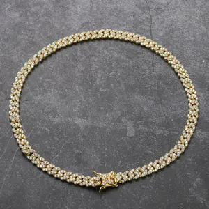 Detailed close-up of 8mm gold Cuban link necklace with pavé set white zircon stones