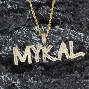 Close-up of MYKAL custom pendant with micro-pave cubic zirconia on a gold rope chain