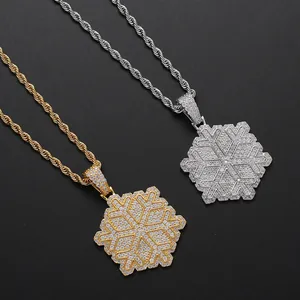 Macro shot of gold and silver snowflake pendants with zircon pave on rope chains