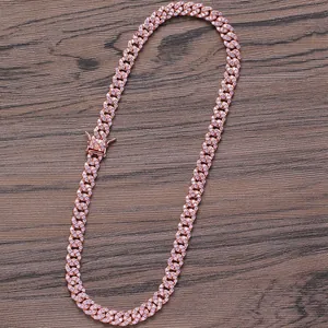 Macro detail of 8mm rose gold Cuban chain with pink cubic zirconia and secure box clasp