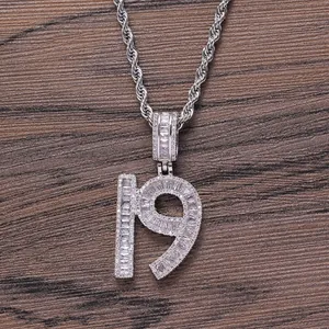 Macro detail of silver number 19 pendant with baguette and round cubic zirconia stones