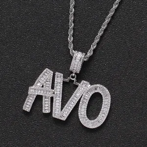 Detailed macro view of iced out AVO letter pendant with cubic zirconia and rope chain