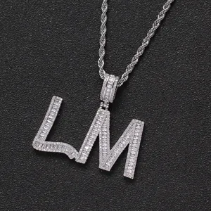 Macro detail of LM letter pendant featuring sparkling cubic zirconia and silver rope chain