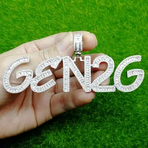 Macro shot of silver hip hop GEN2G letter pendant with cubic zirconia on grass