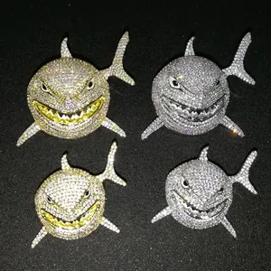 Close-up of hip-hop shark pendants in gold and silver colors with shimmering cubic zirconia