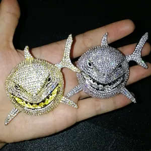 Close-up of hip hop shark pendant with paved zircons in gold and silver finish
