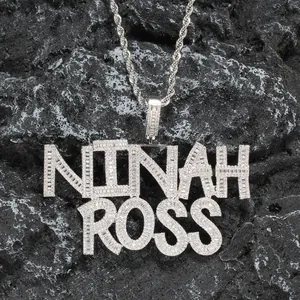 Detail of silver-plated hip hop necklace with NINAH ROSS lettering and zircon stones