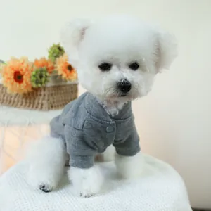 Detail of grey pet sweatshirt with ribbed cuffs and button on white Bichon Frise