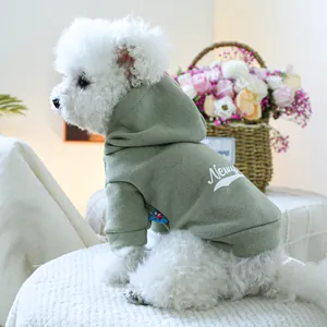 Cozy sage green pet hoodie with Newy print for small dogs shown on a white Bichon