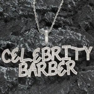 Macro shot of silver iced out Celebrity Barber pendant with cubic zirconia inlay detail