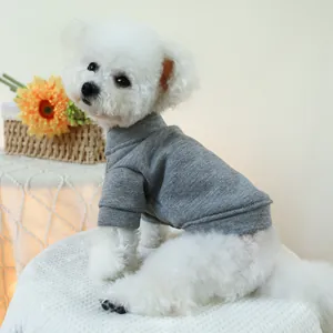 Close-up of a grey knit pet sweater with a high neck on a small white dog