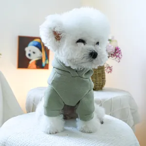 Sage green hooded pet sweatshirt for small dogs on a white Bichon Frise puppy