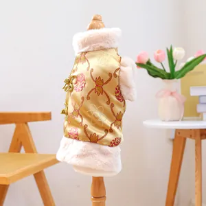 Close-up of golden pet Tang suit vest with floral patterns and white faux fur trim
