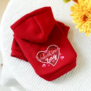 Red Valentine's Day dog hoodie with heart print on cozy white fabric background