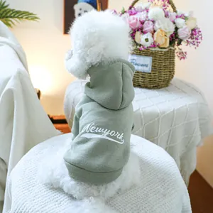 Close-up of sage green pet hoodie with white New York text print and soft ribbed cuffs