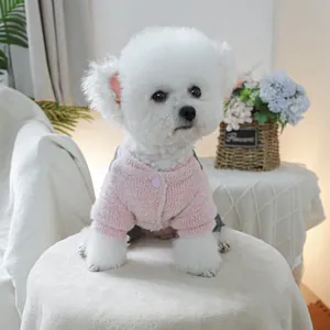 Pink chunky knit pet cardigan detail with purple button and soft cozy texture