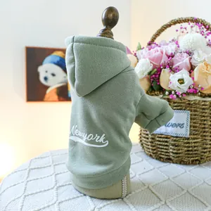 Detailed close-up of green New York pet hoodie with ribbed cuffs and thick cotton fabric