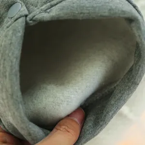 Detail of grey pet sweatshirt showing warm fleece lining and snap button closure