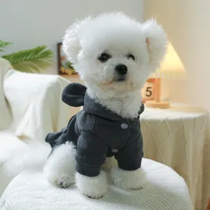 Detail of dark grey dog hoodie with cute ears and snap buttons on a white bichon frise