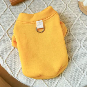 Detail of yellow pet vest featuring reinforced D-ring for leash attachment