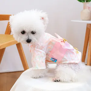 Detail of pet kimono with cherry blossom prints and a large bow on small white dog